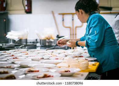 Chef Garnishing With Cheese Plates Dishes In Commercial Industrial Professional Kitchen Galley For Event Party