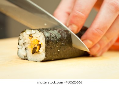 Chef girl in a white coat makes the sushi on a black table. close-up
 - Powered by Shutterstock