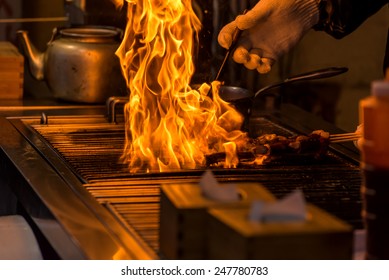 Chef Grilling Bbq With Flame Of Burning In Restaurant.