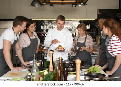 Chef and group of young people during cooking classes - Powered by Shutterstock