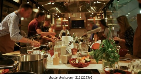 Chef And Group Of Young People During Cooking Classes. Lifestyle Photography Of A Cooking Class Taking Place At  Cooking School