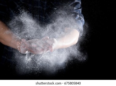 Chef Hand Clap With Splash Of White Flour And Black Background