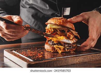 chef hand cooking cheese burger on restaurant kitchen - Powered by Shutterstock