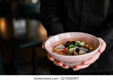 chef hand hold bowl with Japanese clam miso soup - Powered by Shutterstock