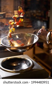 Chef Hand Keep Wok. Closeup Hands Tossing Food At Professional Dark Kitchen. Chef In Prepare Asian Food. Food Delivery Concept, Fast Food