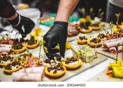 Chef hand is in process of Preparing catering food