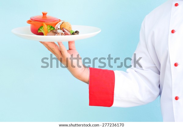 Chef Hand Serving Food On Blue Stock Photo 277236170 Shutterstock