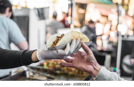 Chef Handing A Taco To A Foodie At A Street Food Market