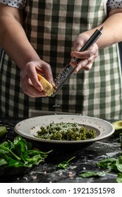 Chef Hands Cooking Penne Vegan Pasta With Fresh Spinach Leaves. Sprinkling Cheese On Green Pasta With Spinach And Green Pesto, Vertical Image, Place For Text.