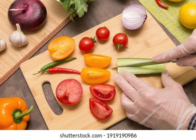 Chef Hands In Latex Gloves Cutting Cucumber And Different Vegetables. Cooking Healthy Vegetarian Vegan Diet Food