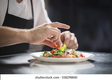 Chef hands preparing vegetable salad - Powered by Shutterstock