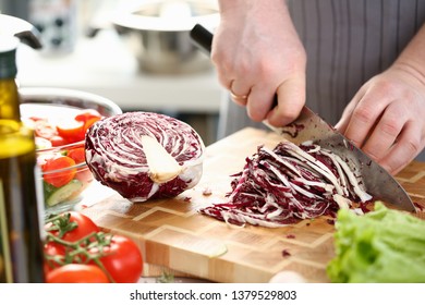 Chef Hands Slicing Purple Salad Cabbage Halve. Male Chopping Red Cole on Cutting Board in Kitchen at Home. Healthy Grocery Culinary Recipe. Fresh Dieting Ingredient Horizontal Photography - Powered by Shutterstock