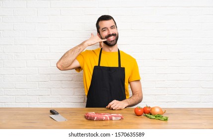 Chef holding in a cuisine making phone gesture. Call me back sign - Powered by Shutterstock