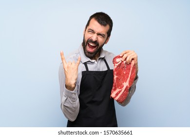Chef Holding A Raw Meat Making Rock Gesture