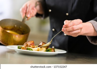 Chef in hotel or restaurant kitchen cooking, only hands to be seen, he is working on the sauce for the food as saucier - Shutterstock ID 137152247