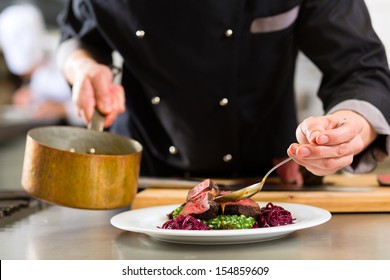 Chef in hotel or restaurant kitchen cooking, only hands, he is working on the sauce for the food as saucier, a Risotto
