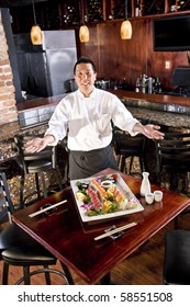 Chef In Japanese Restaurant With Sushi Platter