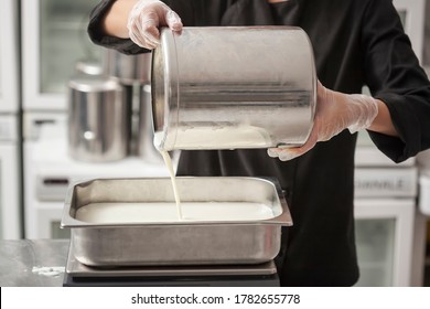 Chef With A Jar Filling Condensed Milk, Making Ice Cream In The Professional Kitchen Of A Small Manufacturing
