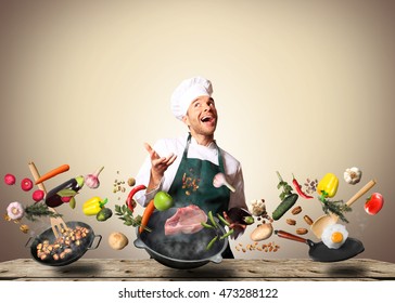 Chef juggling with vegetables and other food in the kitchen - Powered by Shutterstock