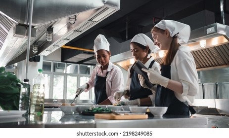 Chef in the kitchen provides cooking training to students.Schoolgirls happily cook together.children wearing cooking uniform. - Powered by Shutterstock