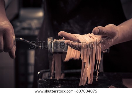 The chef makes fresh spaghetti from scratch.