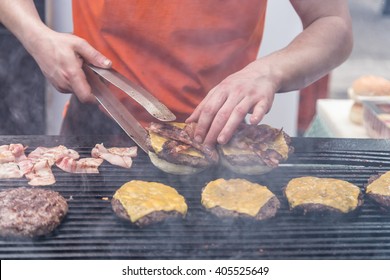 Chef Making Beef Burgers Outdoor On Open Kitchen International Food Festival Event. Street Food Ready To Serve On A Food Stall.