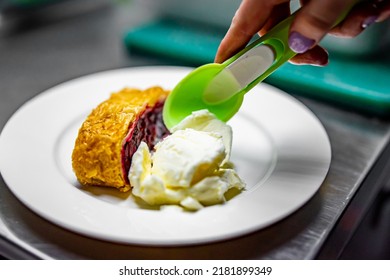 Chef Making Cherry Strudel With Ice Cream