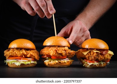 Chef making Chicken burgers with dark background. - Powered by Shutterstock