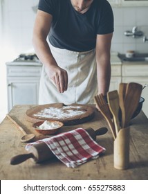 Chef Making Food On Kitchen Table. Baker Man Baking Homemade Bread Dough On Vintage Wooden Board. Retro Style Image. People Cooking In Home Concept.