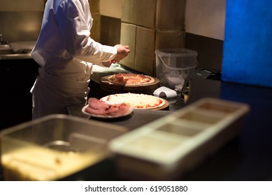 Chef Making Pizza In Kitchen