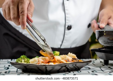 chef making Stir-Fried Broccoli carrot, baby corn with prawns - Shutterstock ID 483873571