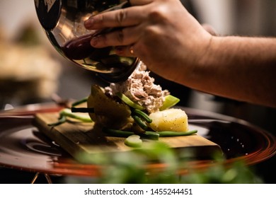 Chef Making Street Food,  Tuna Salad In Hot Potato With Tomato, Eggs And Herbs On Wooden Cutting Board