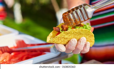 Chef Making Tacos At A Street Cafe. Selective Focus