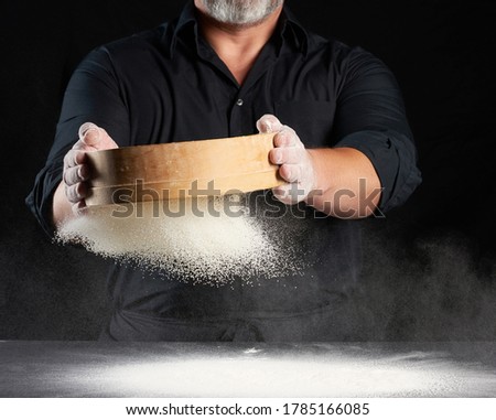 Similar – Image, Stock Photo man sifts white wheat flour through a wooden sieve