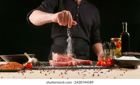 Chef marinates meat on a dark background. Pork ribs, fresh meat, marinated. Restaurant menu concept, recipes and cooking delicious food. - Powered by Shutterstock