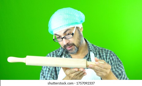 Chef Mid 35-45 Steward Cooking
Put On A White Apron Wearing Black Glasses Wear A Hood Bearded Handhold
Rolling Pin  Green Screen Background
In Studio.