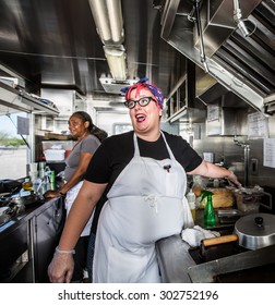 Chef With Pink Hair Directs Staff On Food Truck