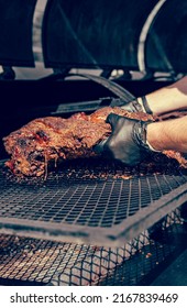 Chef Pitmaster Hand Cooking Grilled Beef Meat In BBQ Smoker.