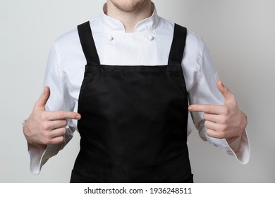 Chef Pointing Fingers At A Black Apron. Mockup. 