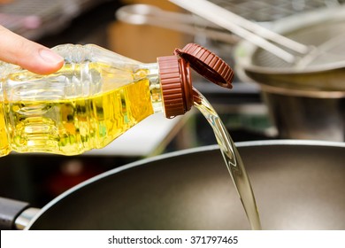 Chef Pouring Oil In To The Frying Pan For Cooking