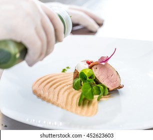 Chef Pouring Sauce Over The Meat Before Serving