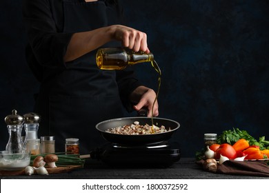 Chef pours olive oil for frying meat with mushrooms for cooking, on the background of vegetables, freezing in motion, culinary recipes, menus, restaurant business, home recipes - Powered by Shutterstock