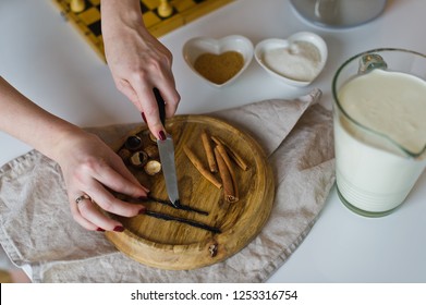 Chef Prepares Dessert Creme Brulee On White Table, Vanilla Pods, Close Up With Hands, White Table Background