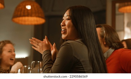 The chef prepares dish in front of people in modern gastro cafe. Multi ethnic friends spend evening, hangout on birthday party in restaurant. Zoom in on cheerful asian woman. Concept of public eating. - Powered by Shutterstock