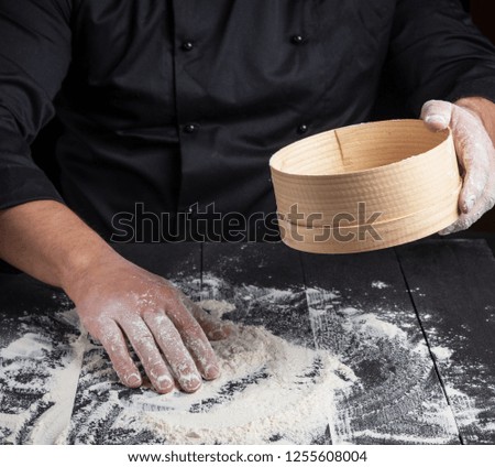 Similar – Image, Stock Photo man sifts white wheat flour through a wooden sieve