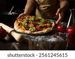 A chef prepares a homemade pizza topped with fresh tomatoes and basil, capturing the essence of traditional Italian cuisine. The cozy kitchen setting enhances the authentic cooking experience.