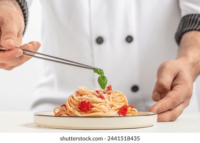 the chef prepares italian pasta with tomato sauce, Concept food menu, - Powered by Shutterstock