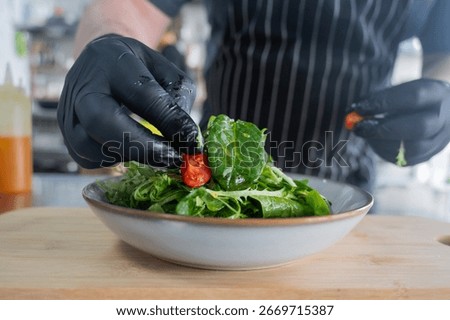 The chef prepares a salad. 