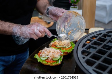 Chef Preparing Burgers With Seafood, Fish On Brazier At Summer Local Food Market - Close Up View. Outdoor Cooking, Gastronomy, Cookery And Street Food Concept