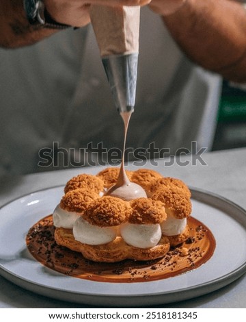 Similar – Image, Stock Photo Concentrated chef adding cream inside ceramic plate